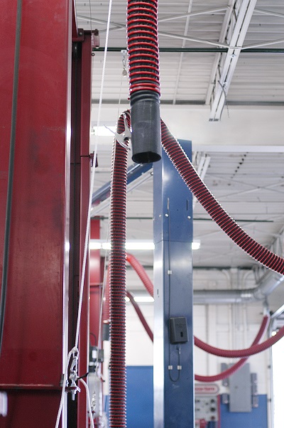 Overhead vehicle exhaust removal system installed to protect repair and maintenance technicians.