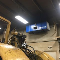 Blue Ox Air Cleaner installed to remove welding and plasma cutting smoke in a construction equipment facility.