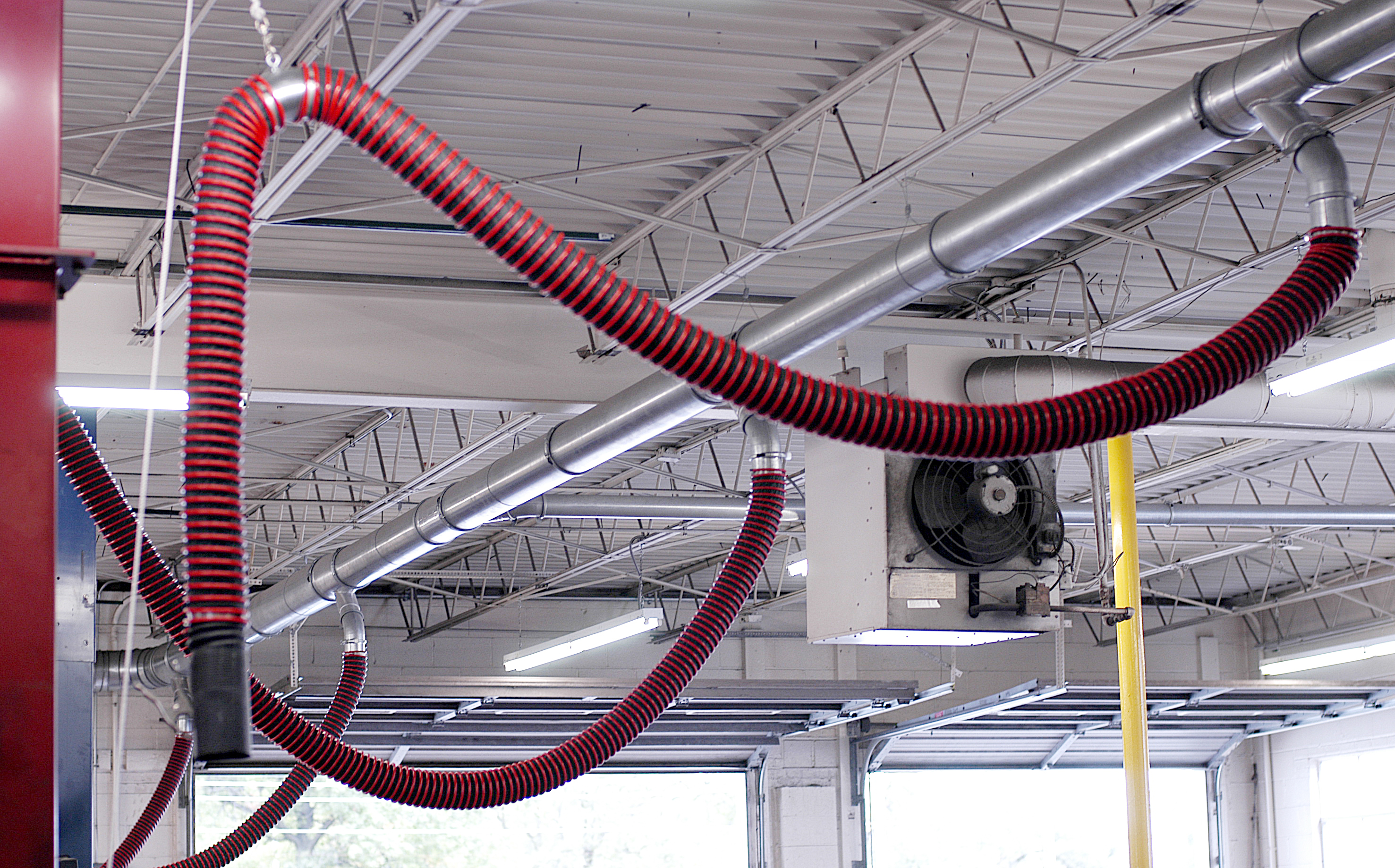 Vehicle exhaust removal systems shown connected to Nordfab Ducting in a maintenance garage.