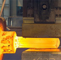A close up of a forging press in action